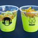 Two plastic cups adorned with Rick and Morty-style art and filled with bright-green Pickle Rick Frosties.